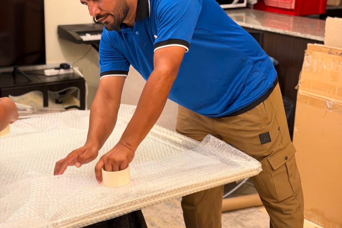 1stMove crew member carefully wrapping items for a kitchen move