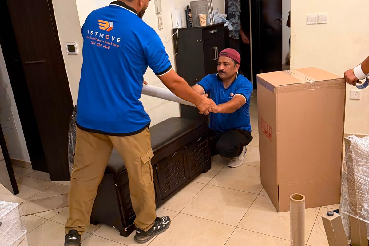 1stMove crew members carefully wrapping furniture during a house move